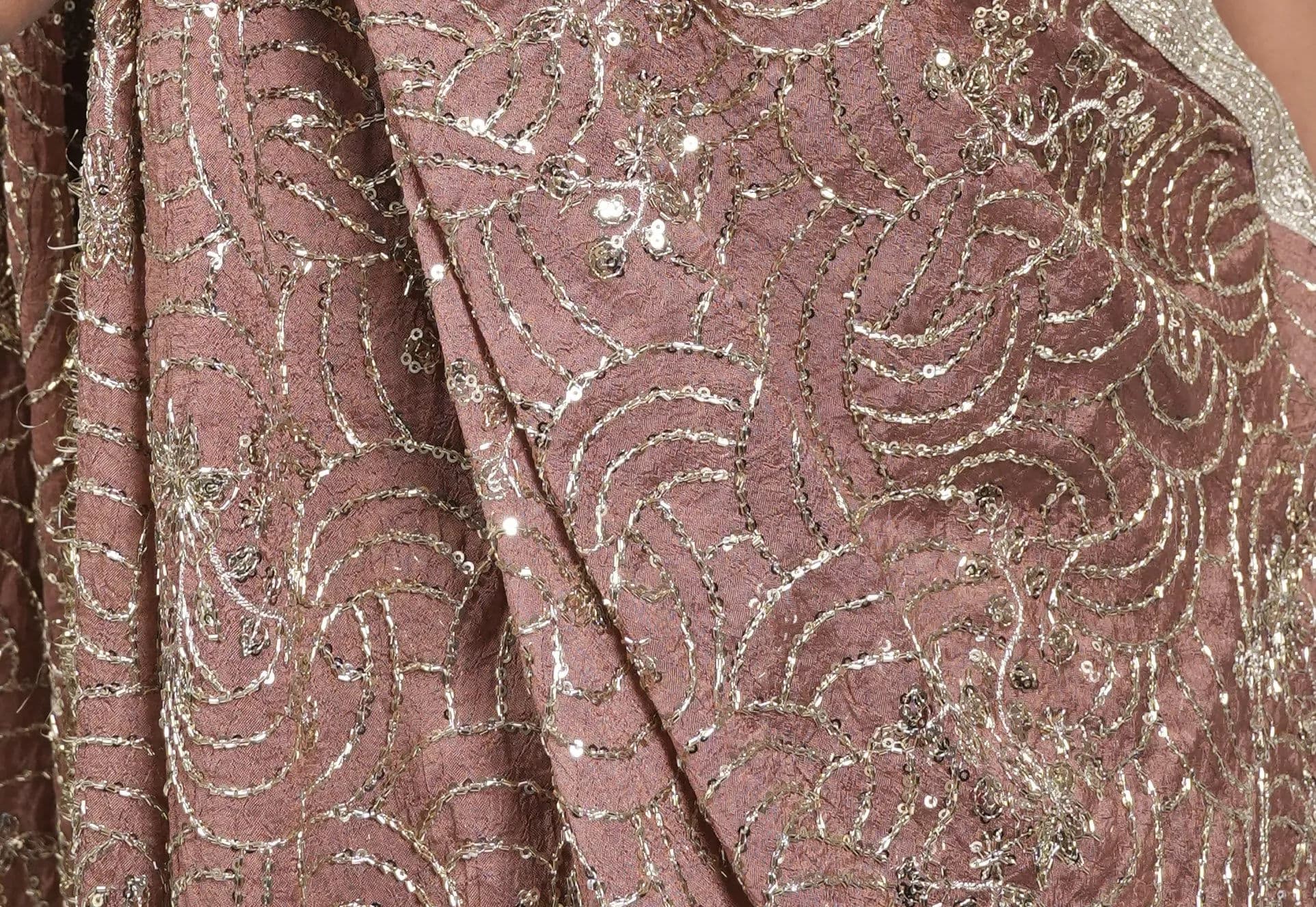 Dusty-rose net embroidered all over with silver sequin swirls, from a Sheshri Fashion lehenga